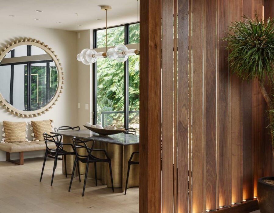 Dining area with reclaimed wood accent wall in a contemporary custom home