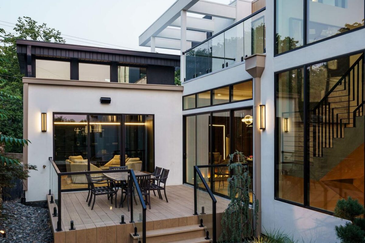 Custom home exterior side yard with stone pathway and modern landscaping