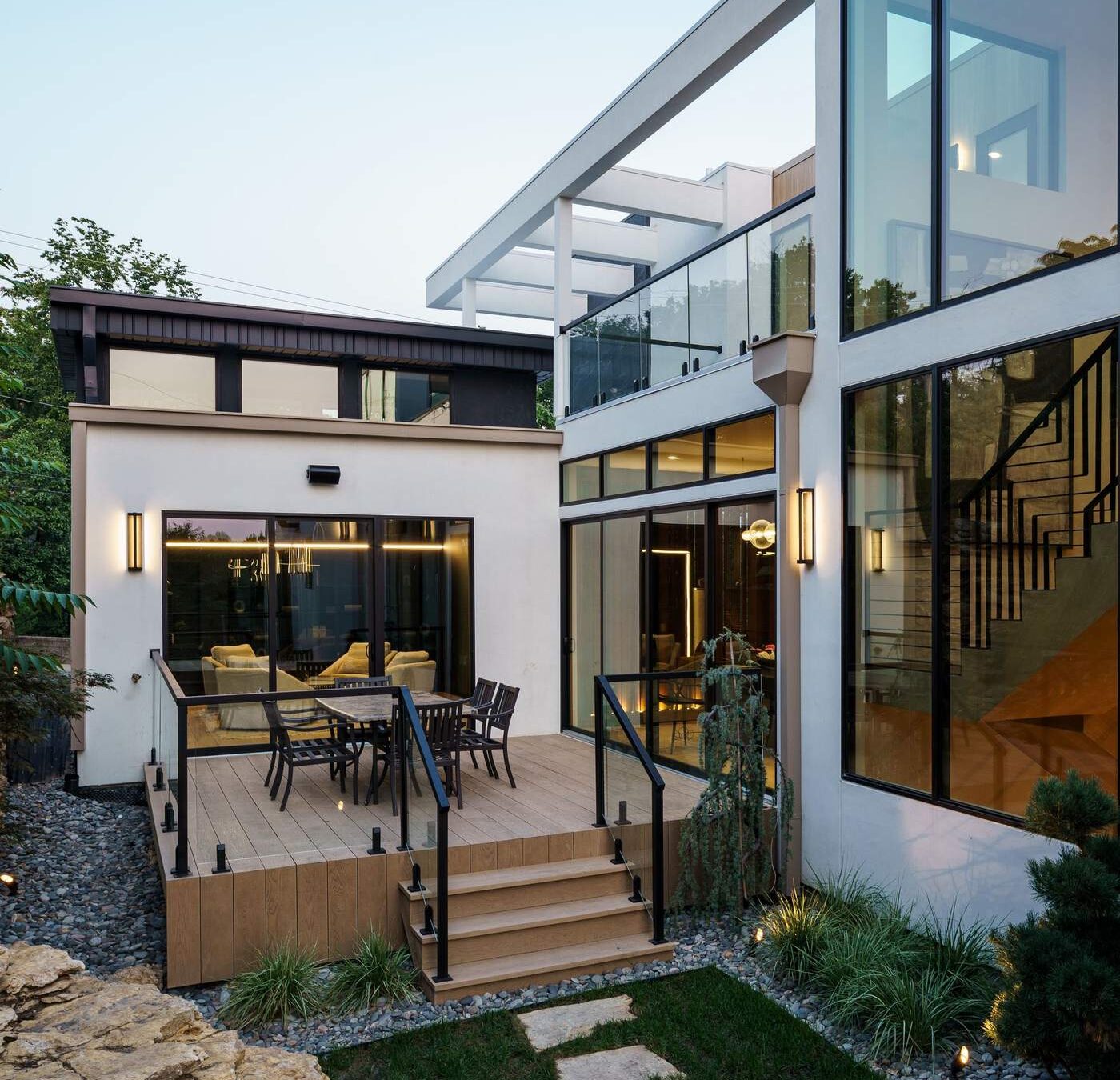Custom home exterior side yard with stone pathway and modern landscaping