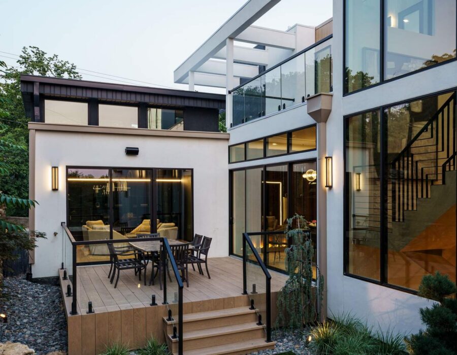 Custom home exterior side yard with stone pathway and modern landscaping