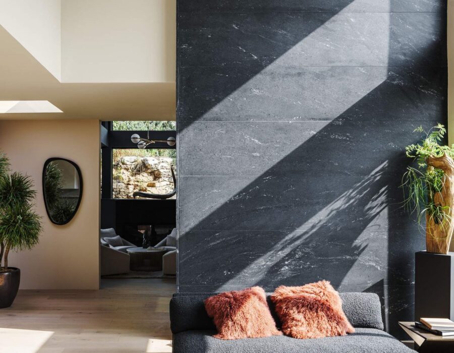 Modern living room entry with slate accent wall and natural light, custom home by Hickok Homes