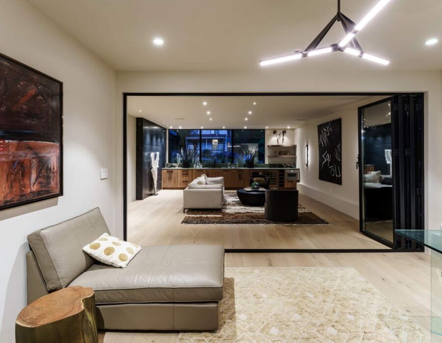 Open-concept living space with floor-to-ceiling windows and designer art