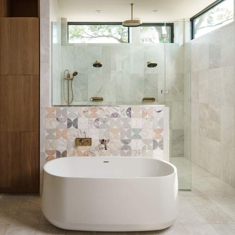 Luxury primary bathroom with freestanding soaking tub and glass walk-in shower, custom home build