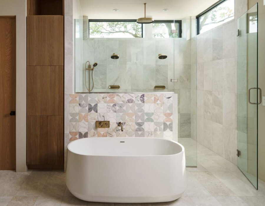 Luxury primary bathroom with freestanding soaking tub and glass walk-in shower, custom home build