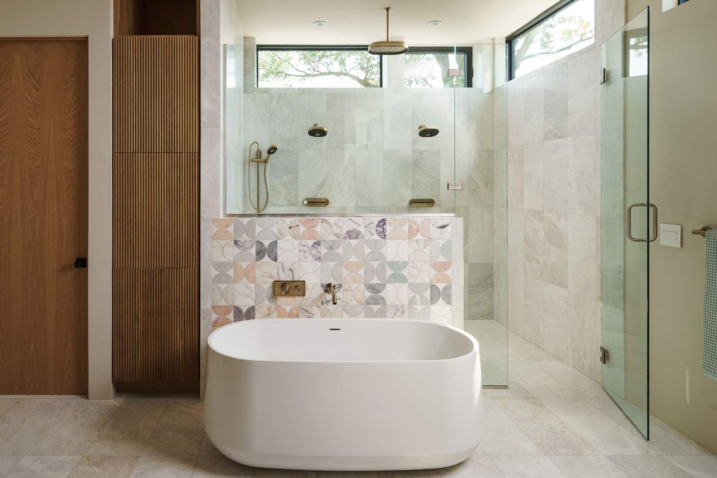 Luxury primary bathroom with freestanding soaking tub and glass walk-in shower, custom home build