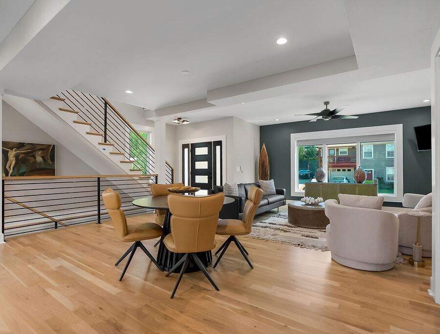 Open living, dining, and staircase view in furnished executive housing