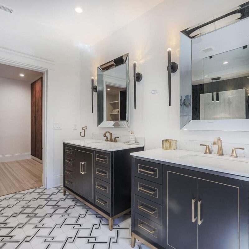 Remodeled bathroom with dual vanity and marble countertops