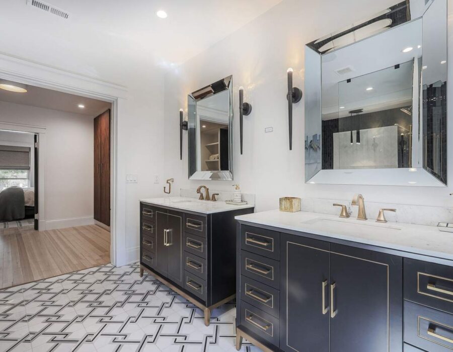 Remodeled bathroom with dual vanity and marble countertops