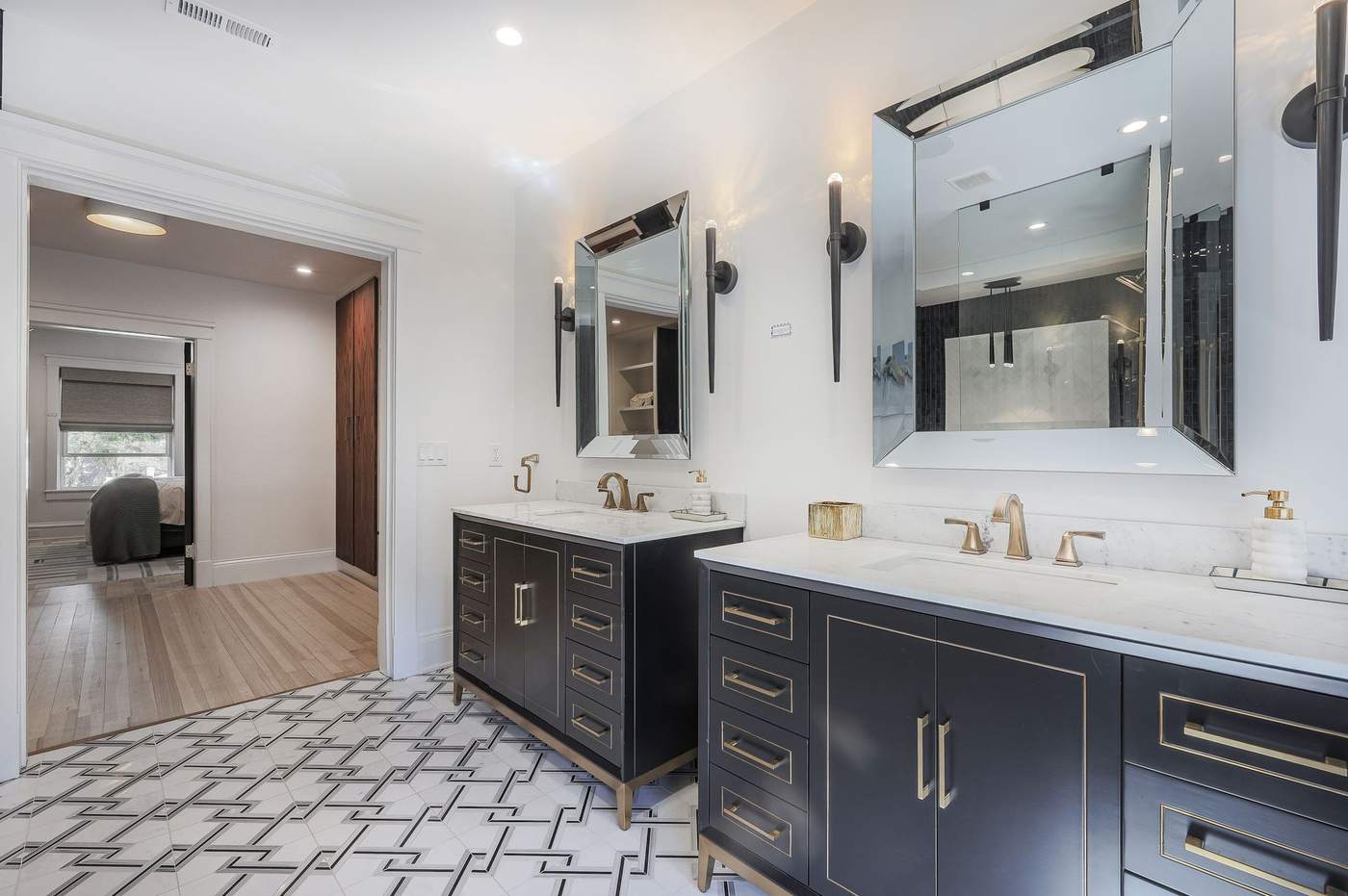 Remodeled bathroom with dual vanity and marble countertops