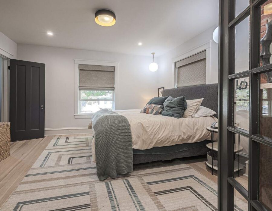 Bedroom suite with custom glass partition added during renovation