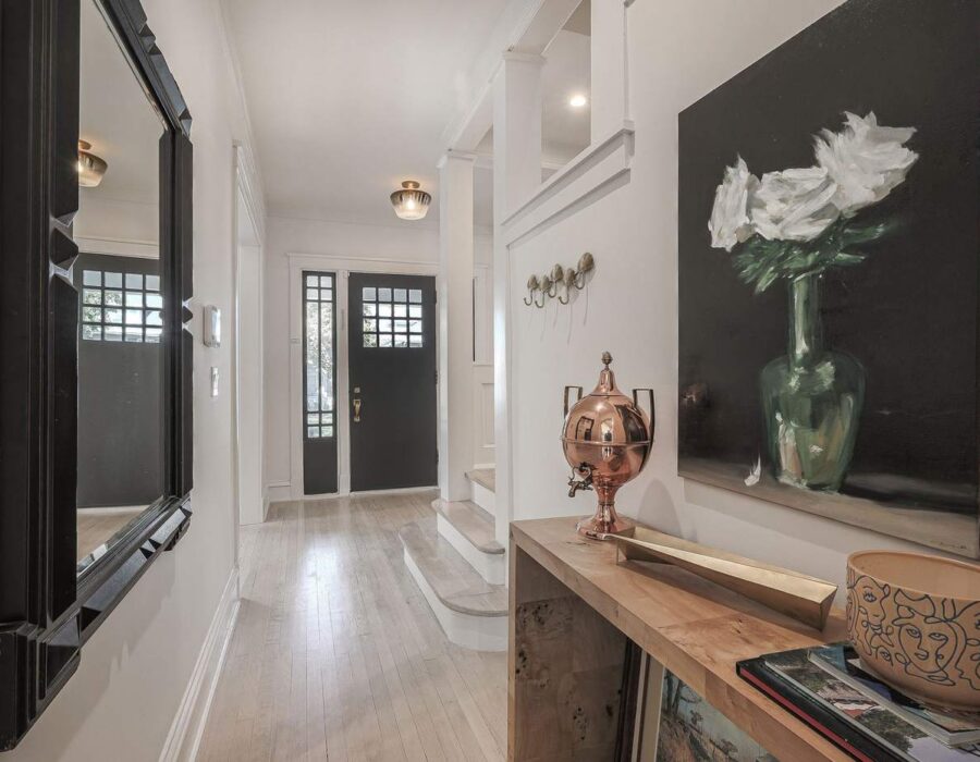 Renovated entry hallway with custom lighting and refinished hardwood floors