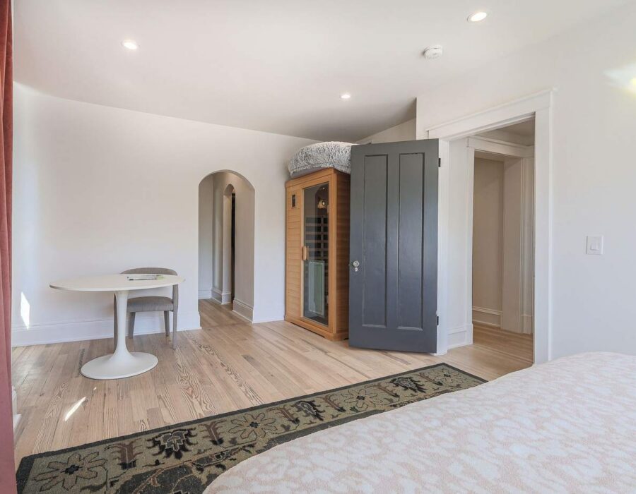 Renovated guest bedroom with restored archways and built-in cabinetry
