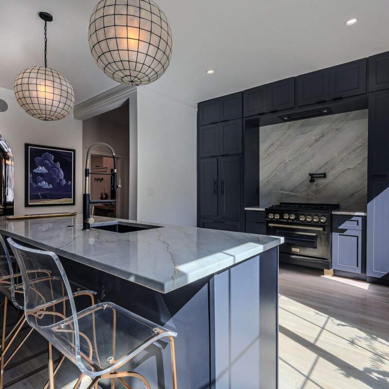 Remodeled kitchen with custom dark cabinetry and built-in bar