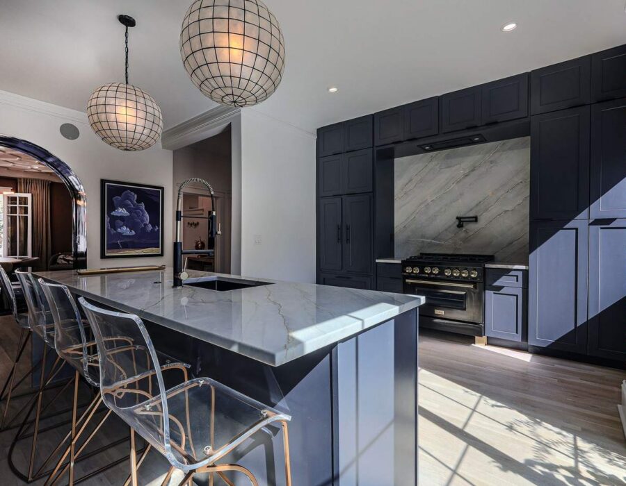 Remodeled kitchen with custom dark cabinetry and built-in bar
