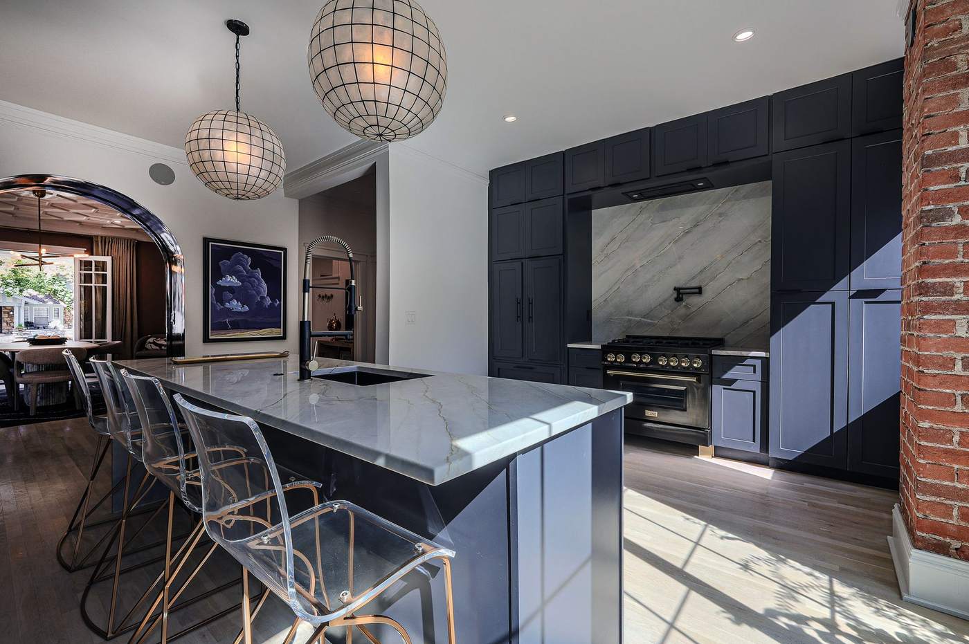 Remodeled kitchen with custom dark cabinetry and built-in bar
