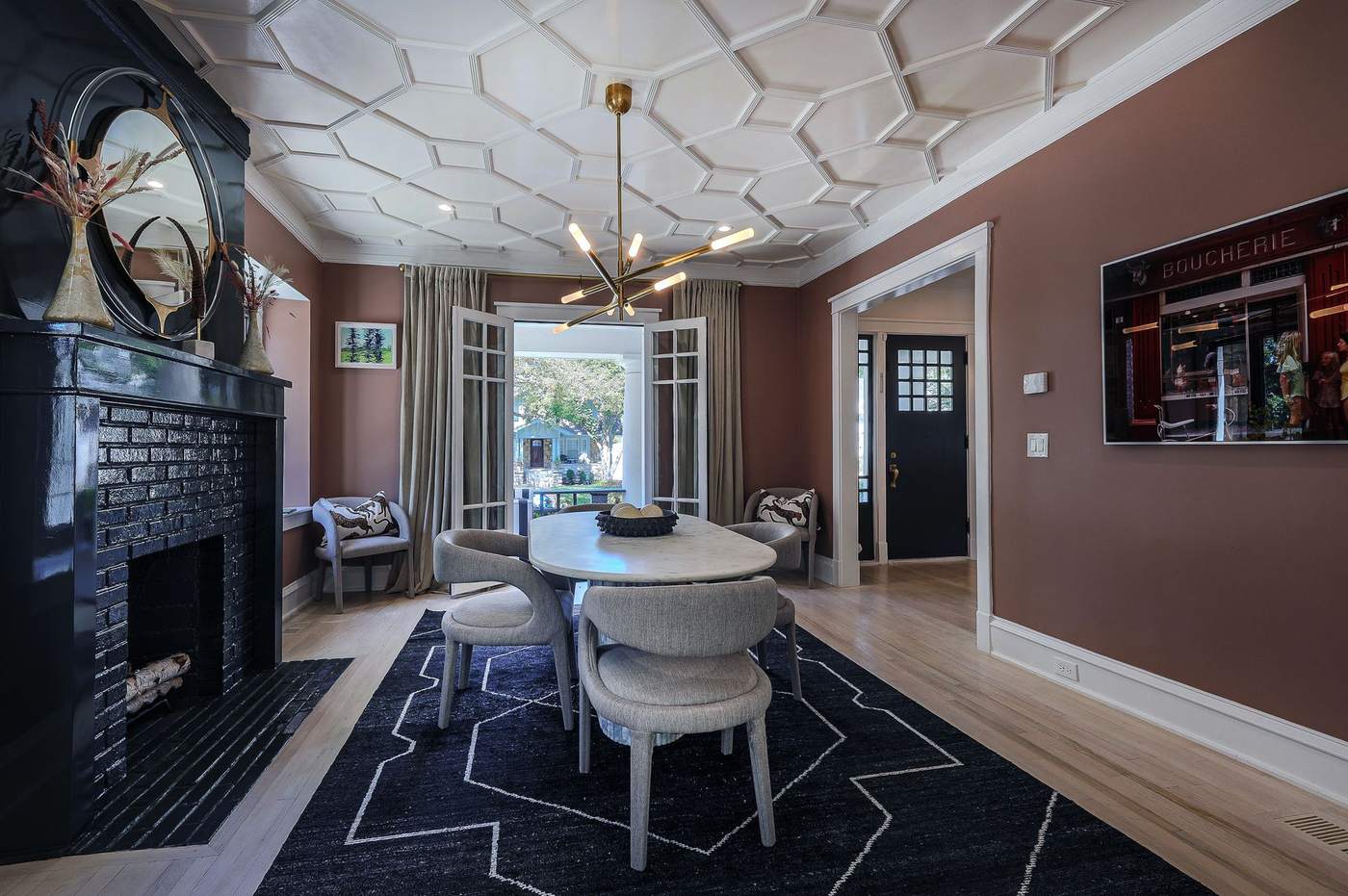 Living room with restored fireplace mantel and custom ceiling detail