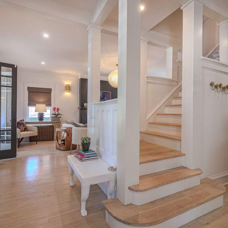 Living room and original staircase restored during a luxury home renovation