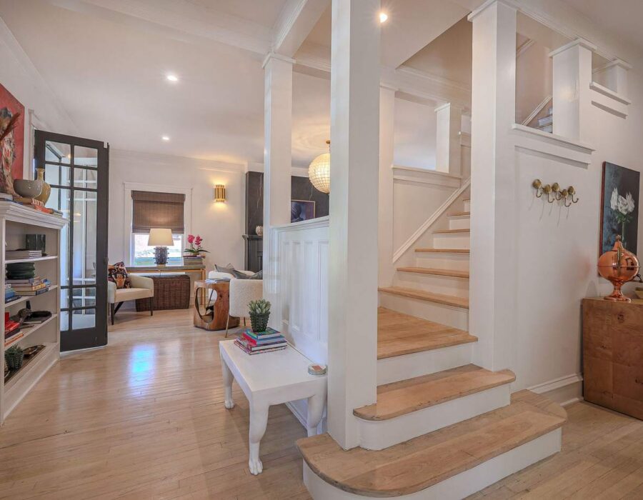 Living room and original staircase restored during a luxury home renovation