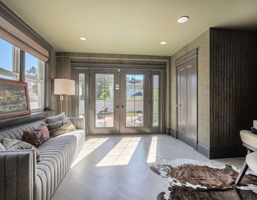 Sunroom-style living area with French doors after a custom renovation