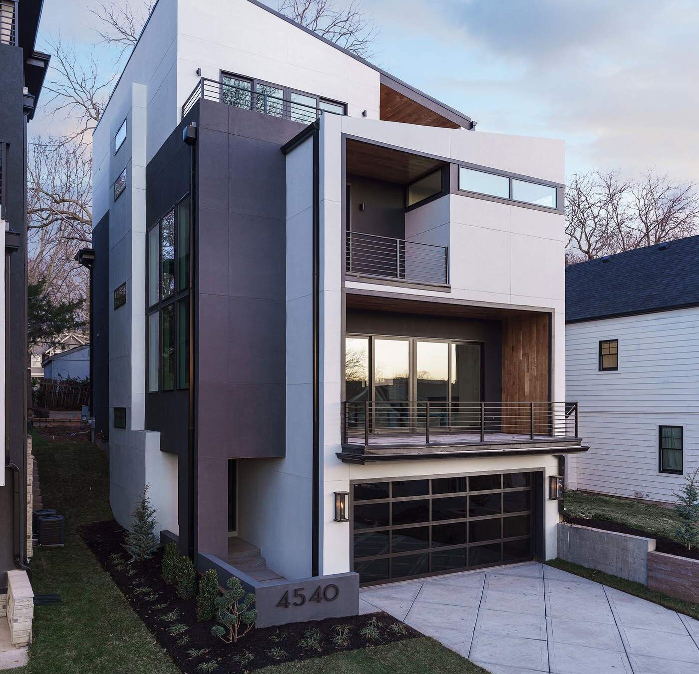 Modern multi-level custom home exterior with wood and stucco facade