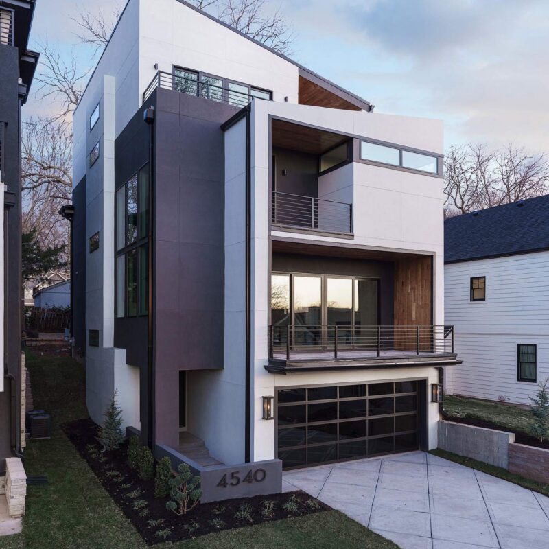 Modern multi-level custom home exterior with wood and stucco facade