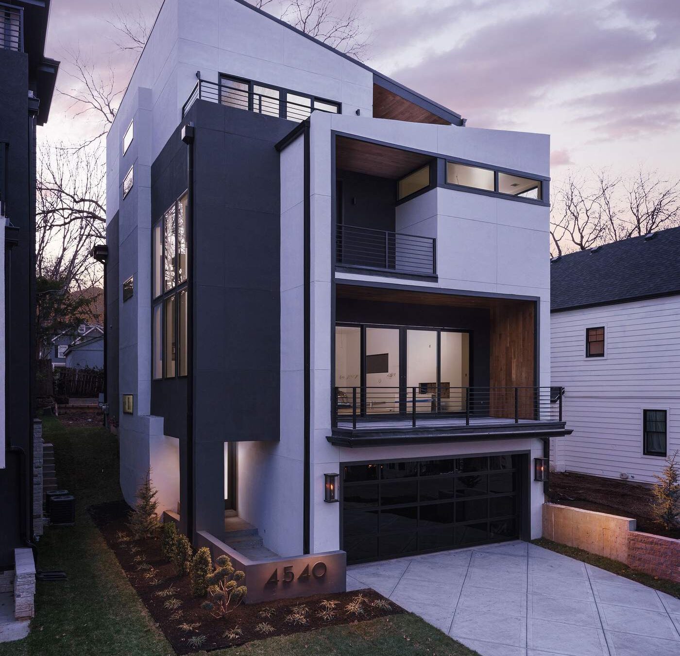 Custom home exterior glowing at dusk, designed and built by Hickok Homes