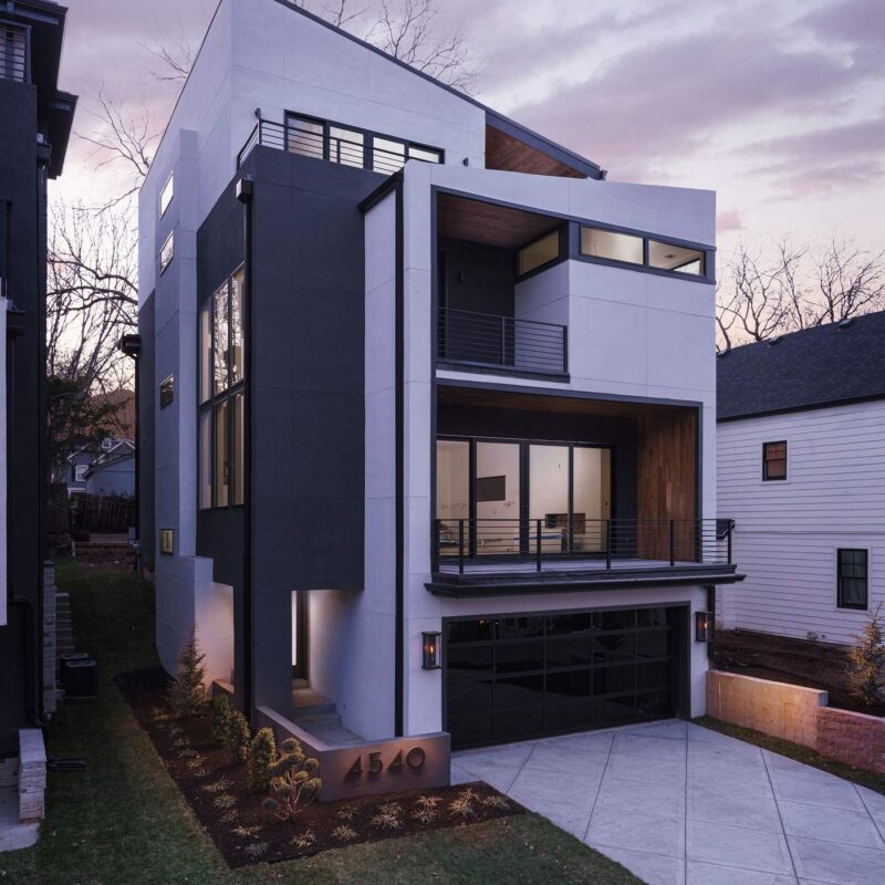 Custom home exterior glowing at dusk, designed and built by Hickok Homes