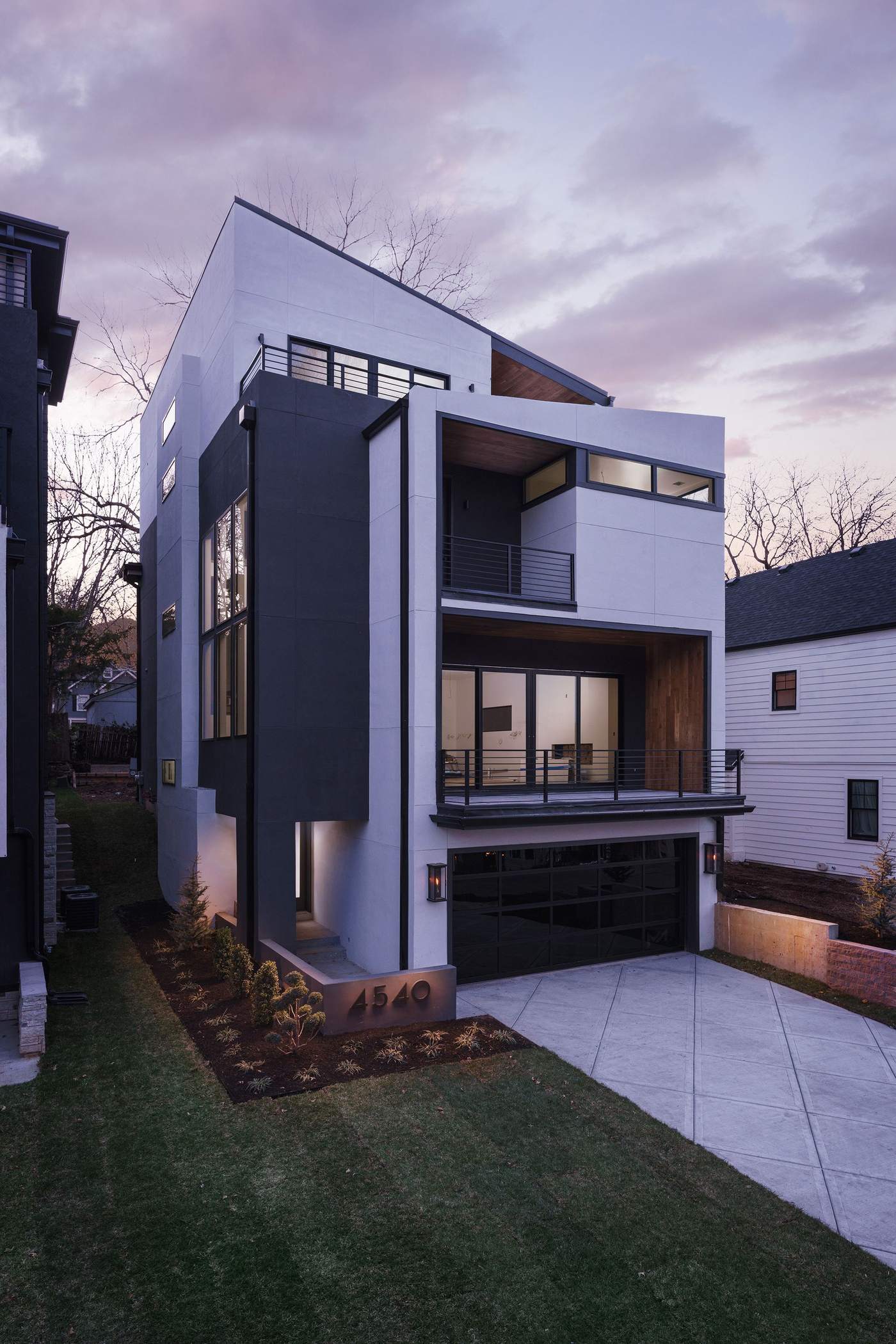 Custom home exterior glowing at dusk — Hickok Homes design-build craftsmanship