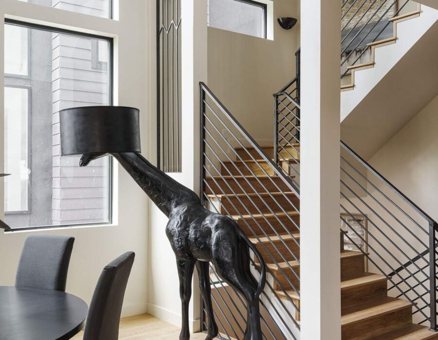 Dining area beneath an open staircase with skylights
