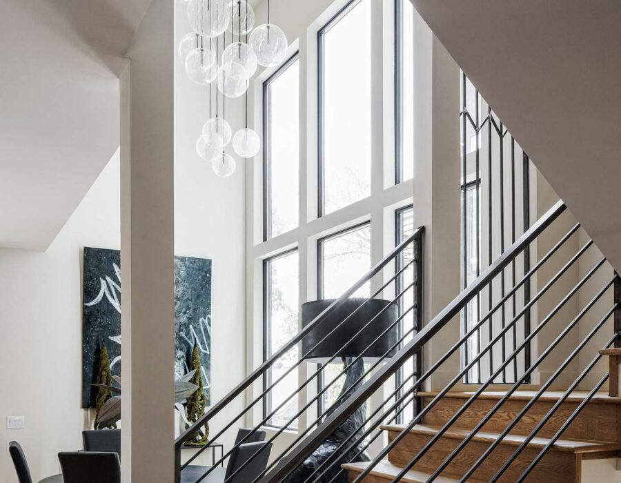 Light-filled entry stairwell with floor-to-ceiling windows