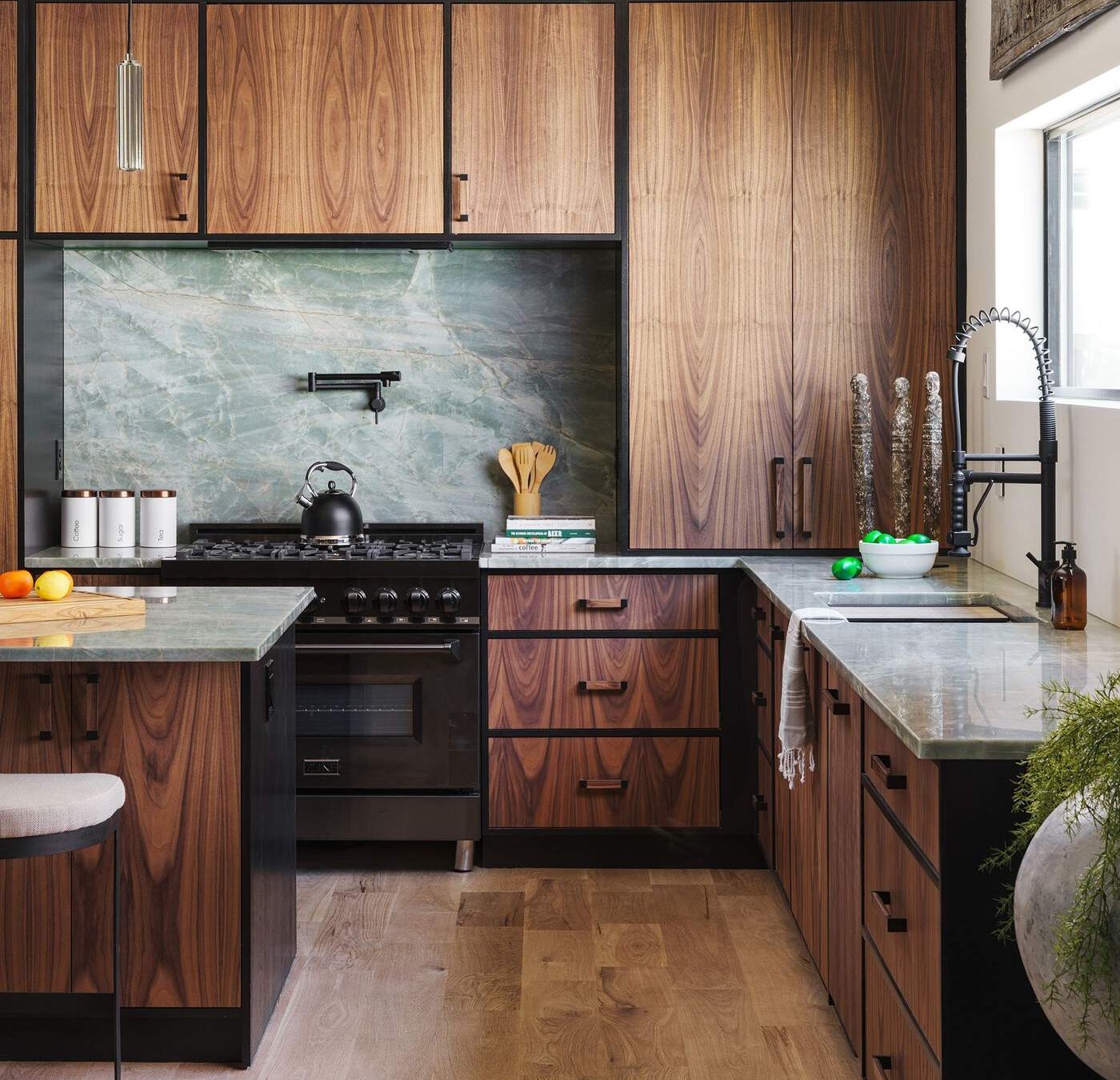 Full kitchen view with stone backsplash and integrated appliances