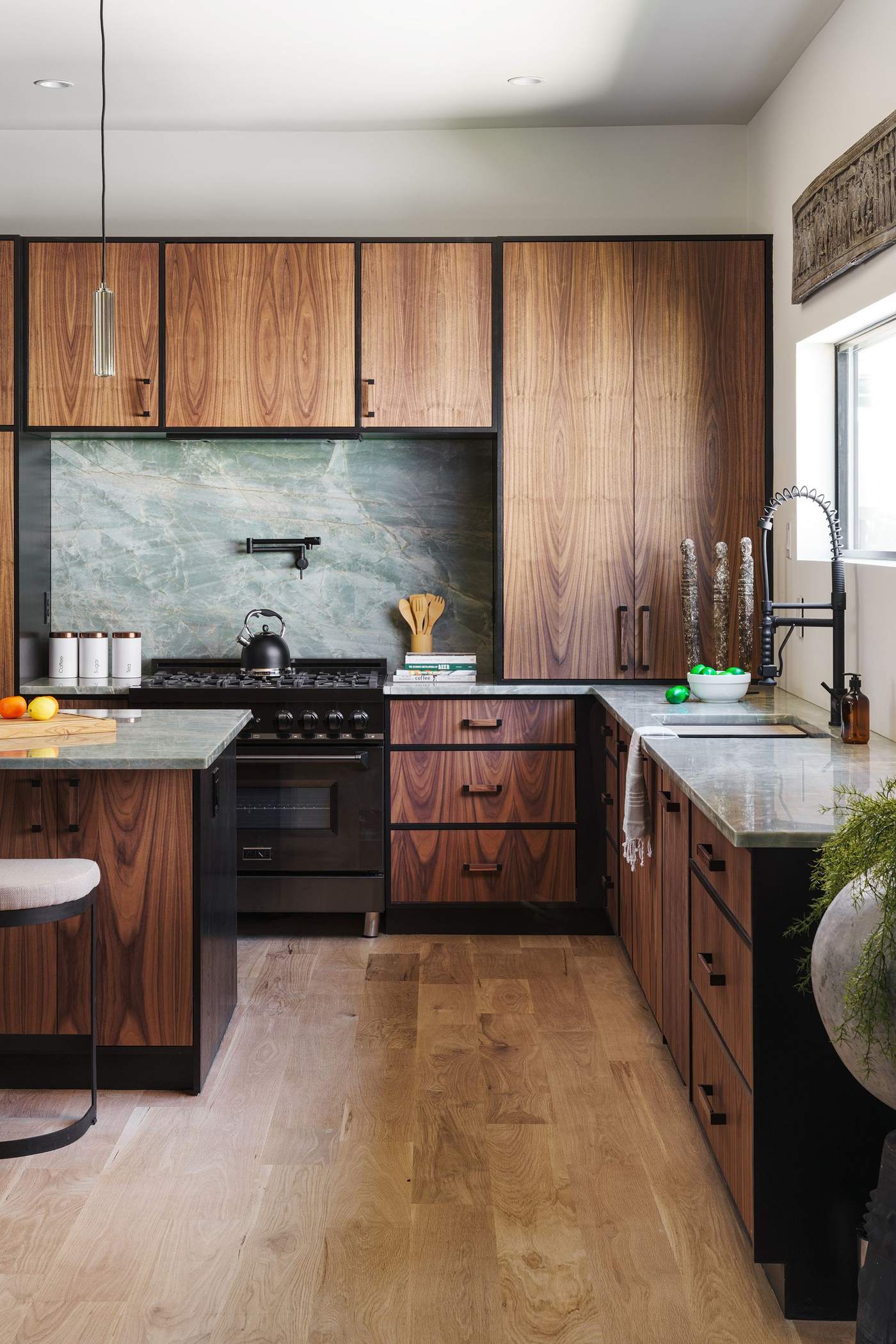 Full kitchen view with stone backsplash and integrated appliances, Hickok Homes craftsmanship