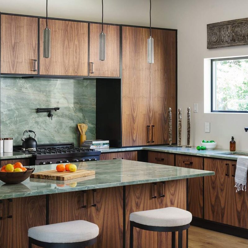 Kitchen island with waterfall stone countertop and bar seating