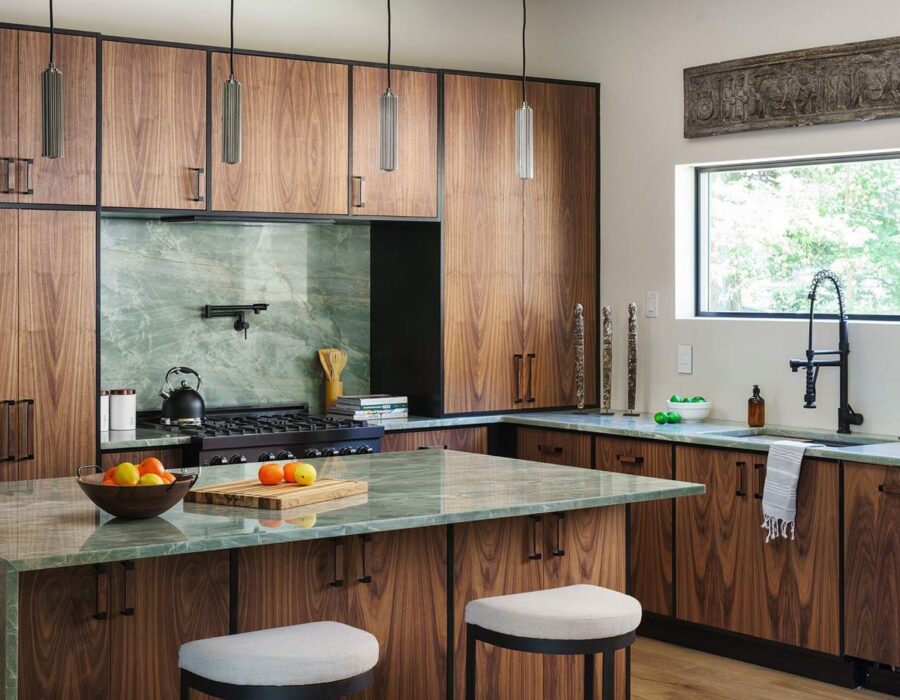 Kitchen island with waterfall stone countertop and bar seating