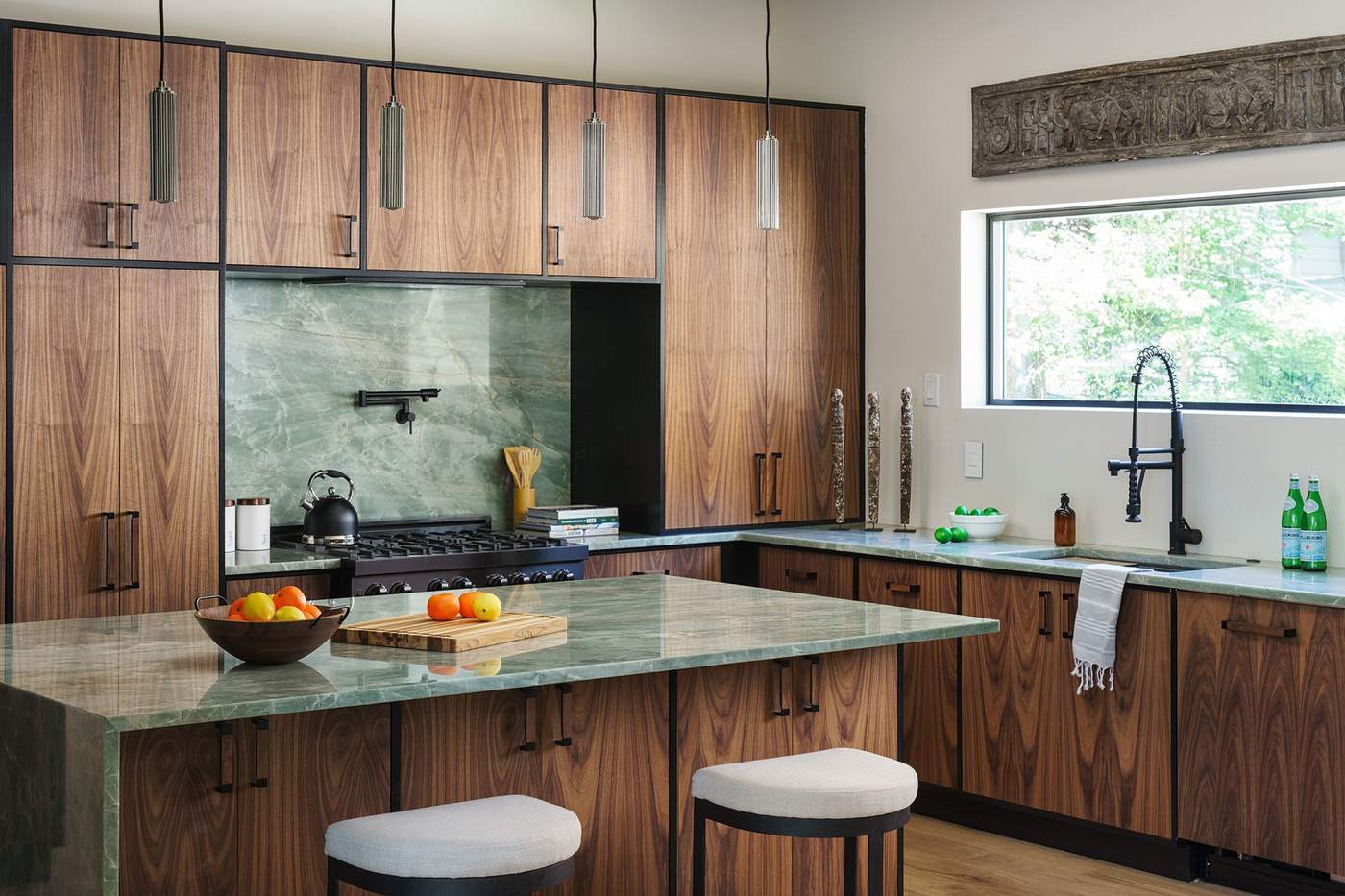 Kitchen island with waterfall stone countertop and bar seating