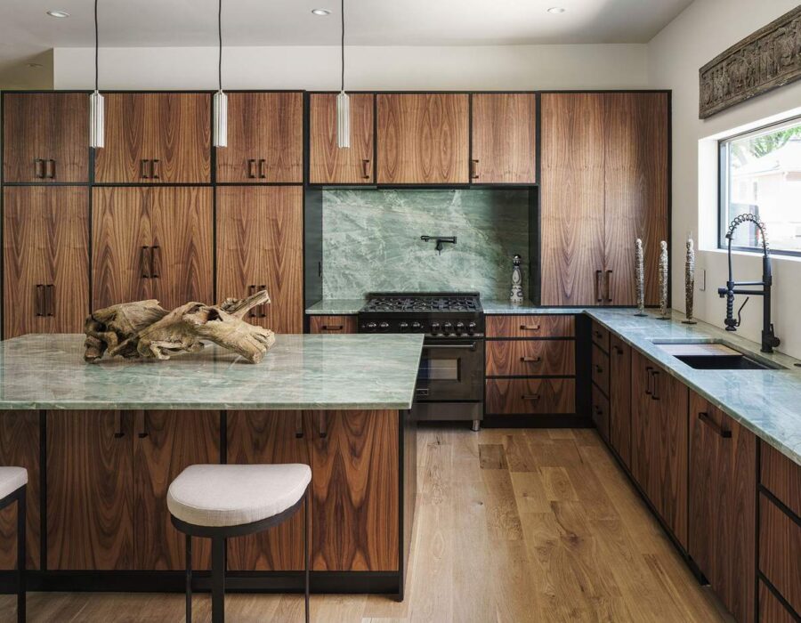 Custom kitchen with walnut cabinetry and green stone backsplash